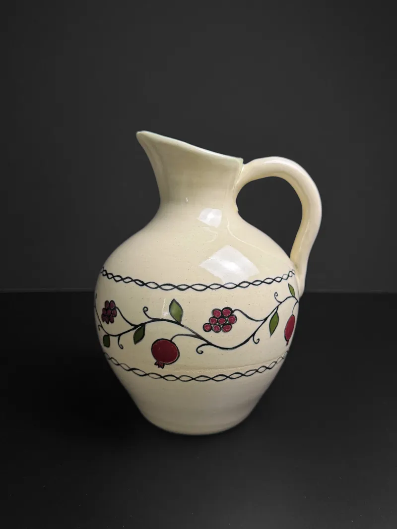 Cream pitcher painted with a pomegranate vine