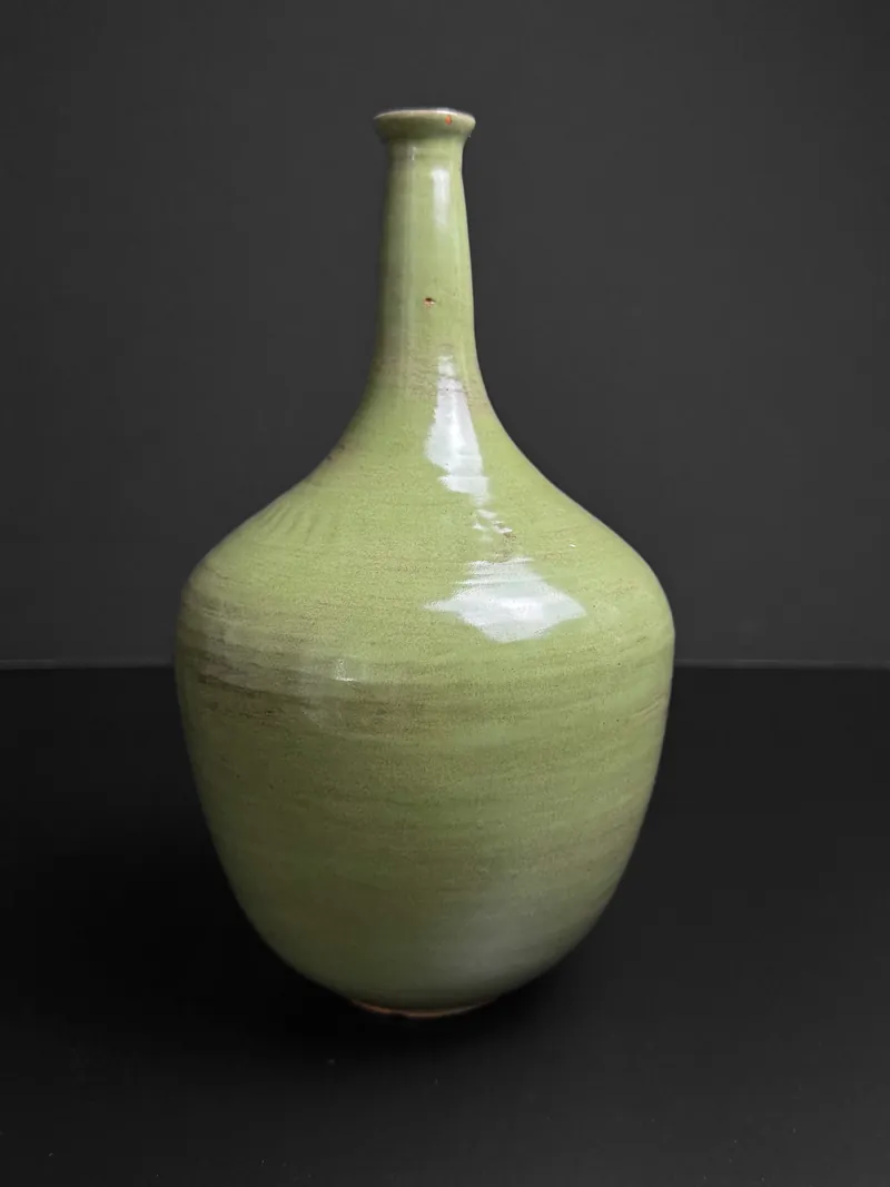 Green bottle vase with a long narrow neck
