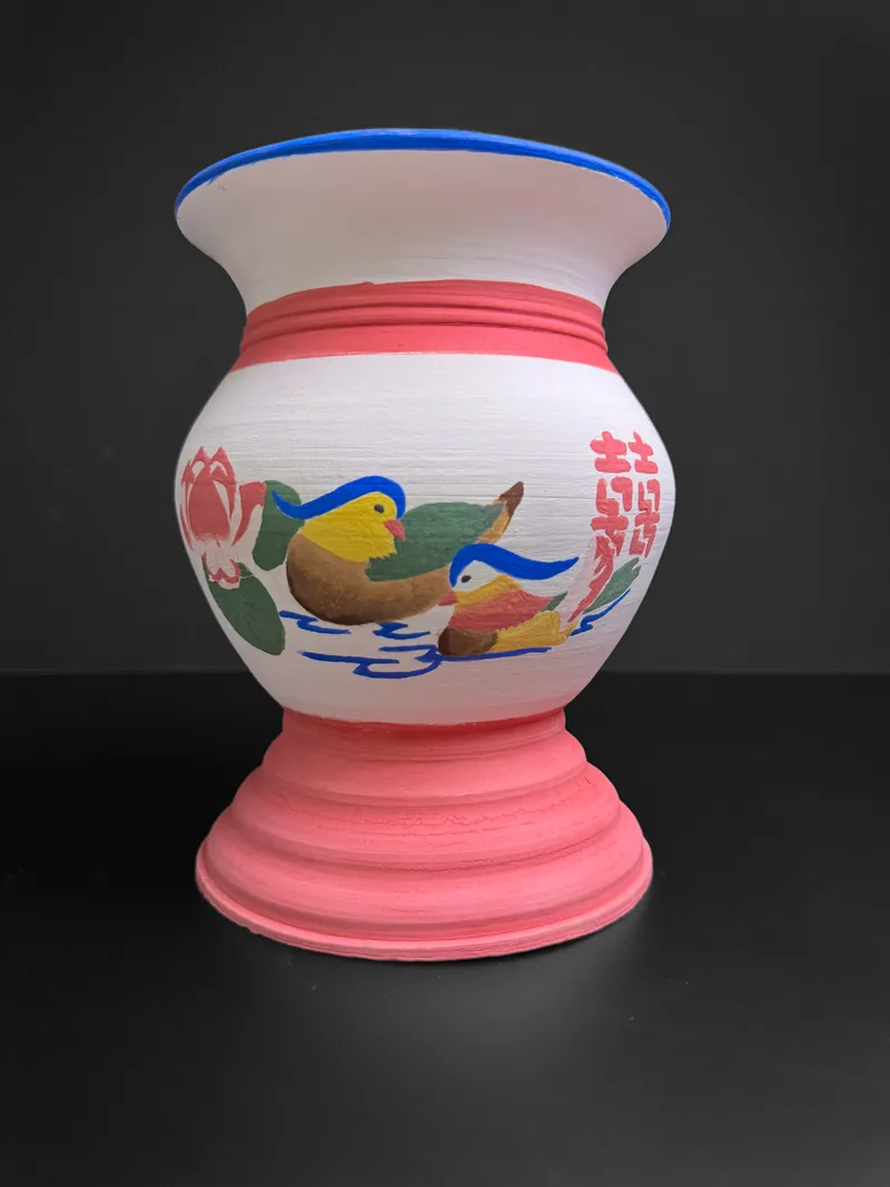 White vase painted with mandarin ducks and lotus on a pink foot