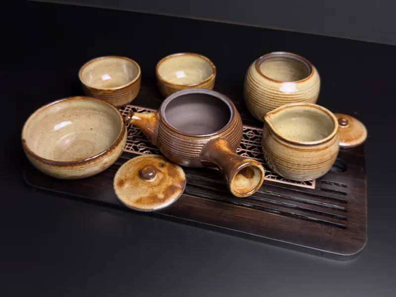 Tan tea set with teapot, cups and bowls on a tray