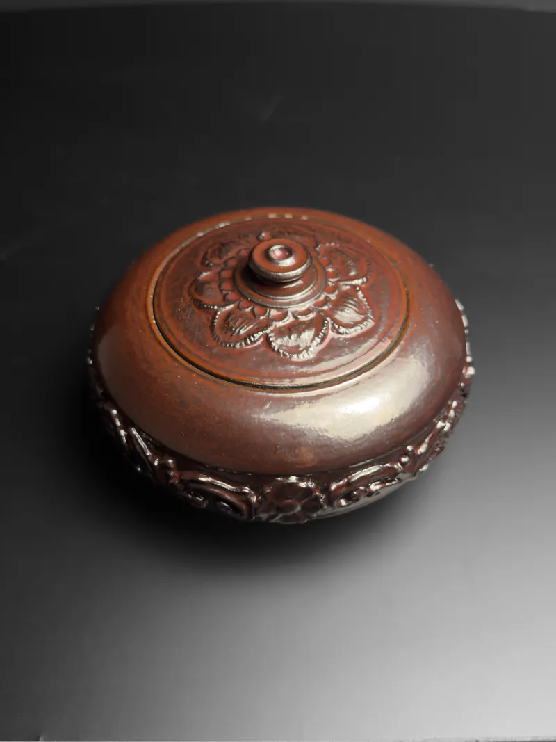 Carved red-brown lidded box