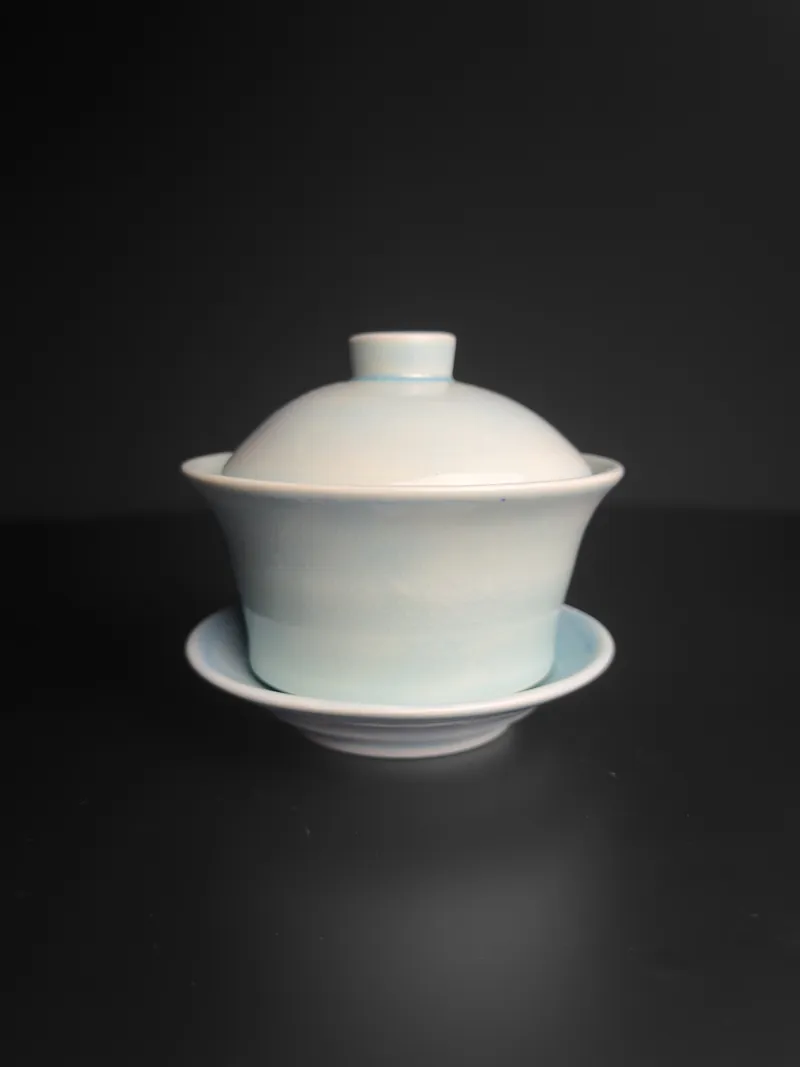 Pale celadon gaiwan on its saucer